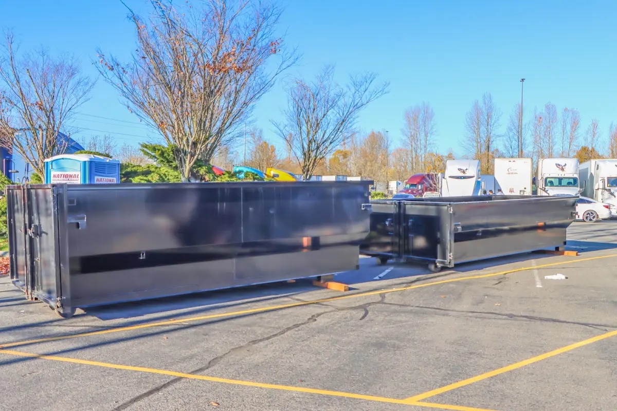 Professional dumpster rental service with roll-off container on residential driveway in Manteno